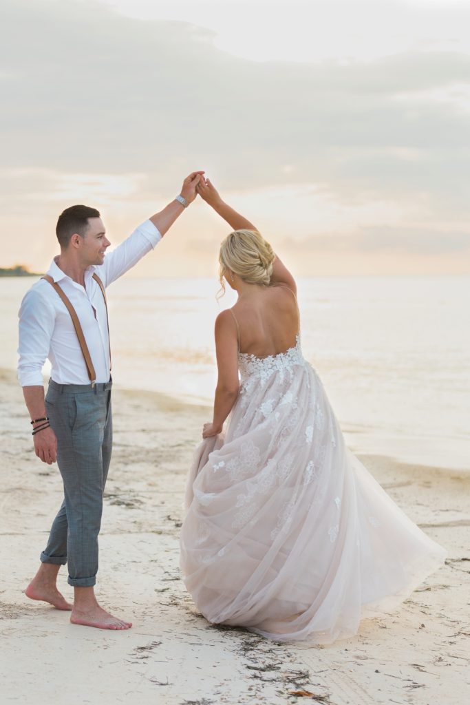 Candid photo of couple dancing on beach
