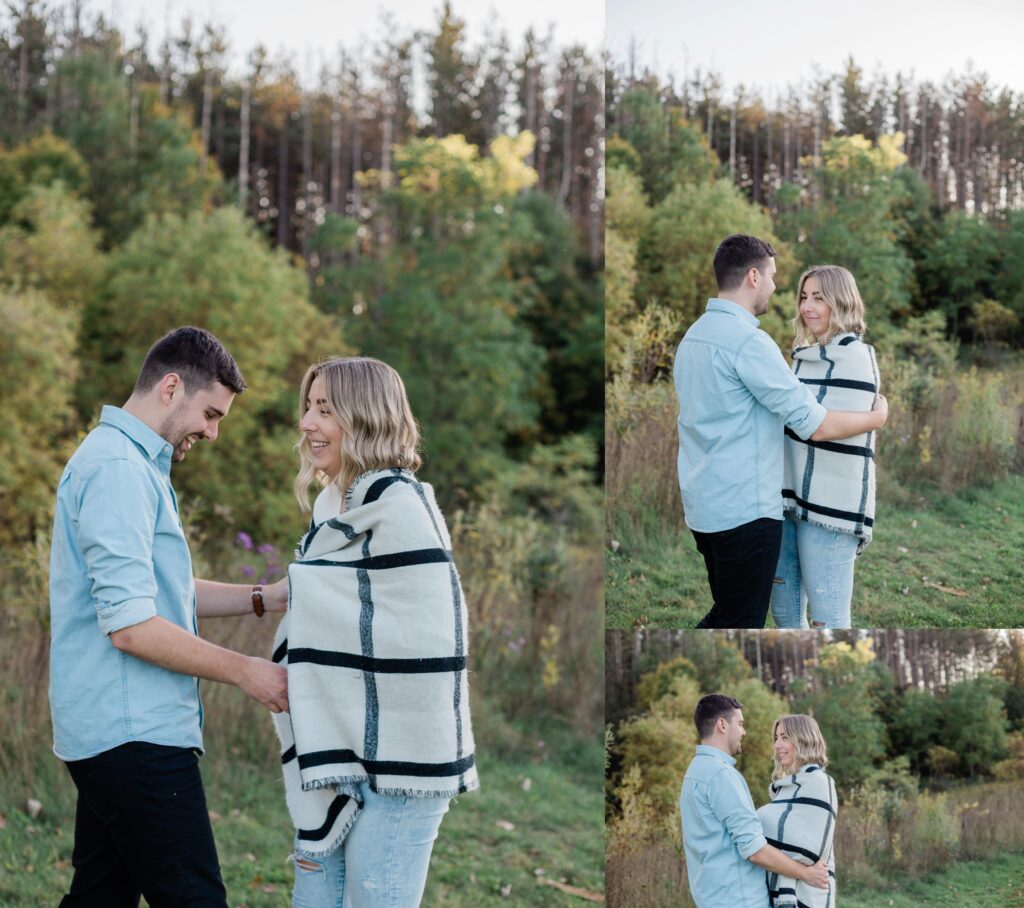 silly engagement session groom wraps bride in blanket