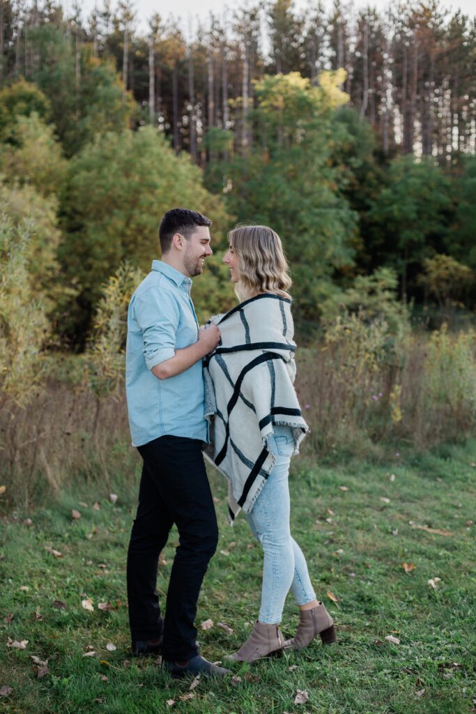 Kitchener photographer engaged couple in field Huron Natural Area