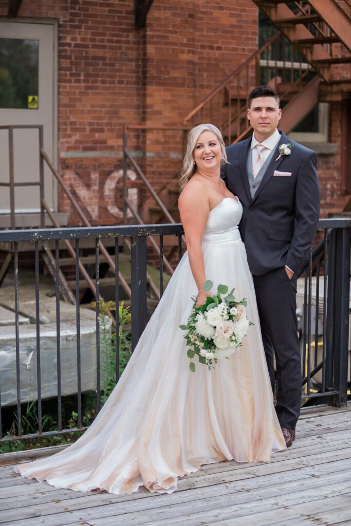 full body portrait of bride and groom with bouquet