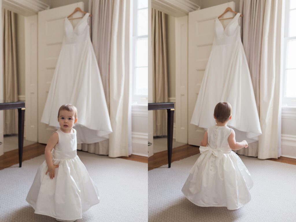Bridal suite wedding gown hanging on door with flower girl twirling