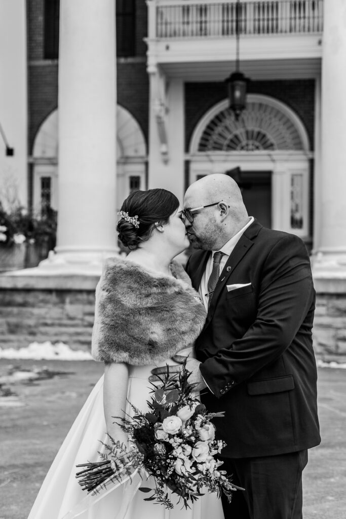 bride and groom kiss in close up shot in front of Langdon Hall entrance