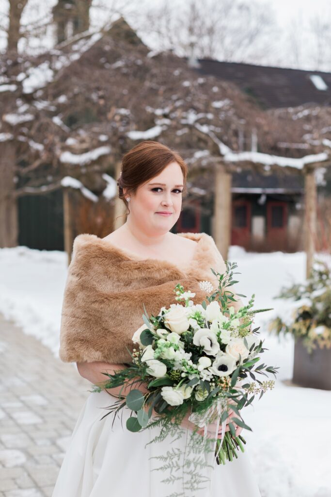 close up of bride smiling at camera outside at winter wedding