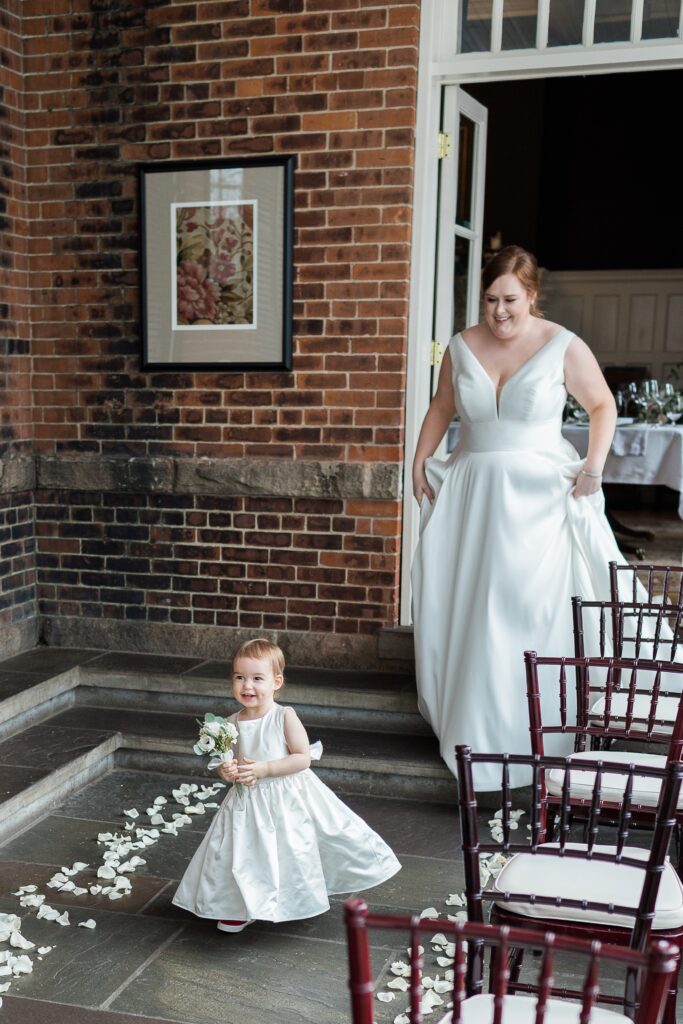 Flower girl walking to dad for first look with bride