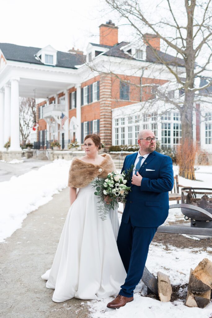 formal portrait of bride and groom outside in winter wedding