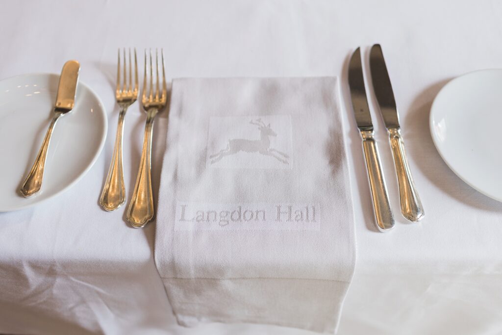 detail photo of cutlery and napkin showing langdon hall logo