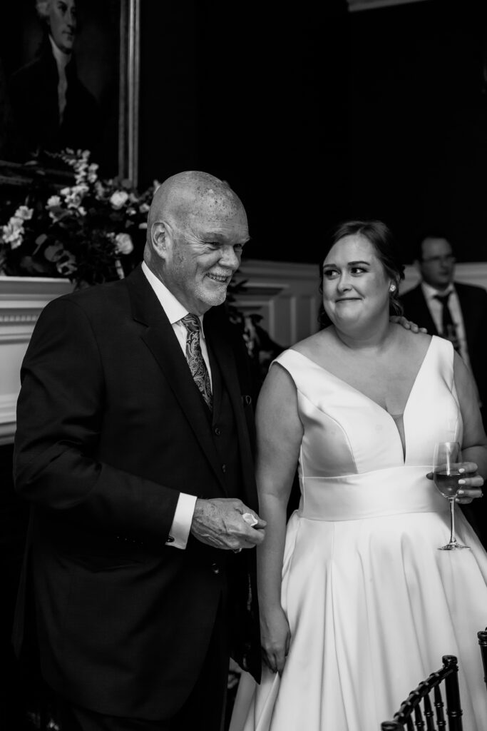 bride and father in law laughing at intimate cocktail hour