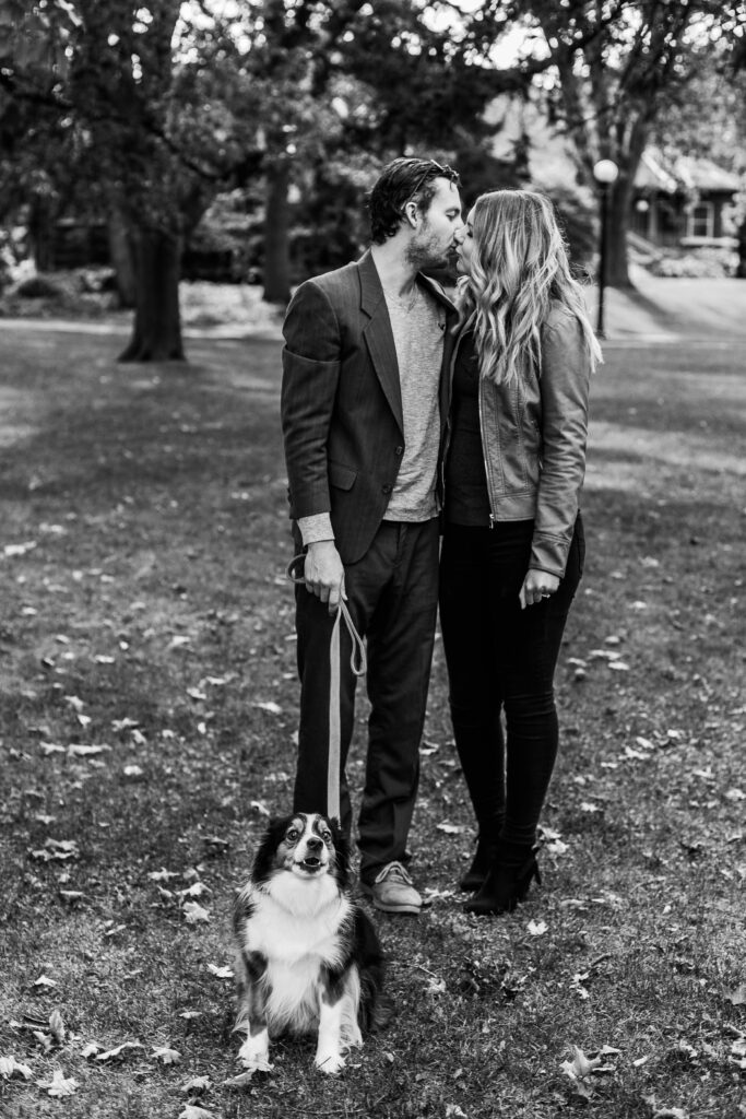 Couple kissing in park in black and white