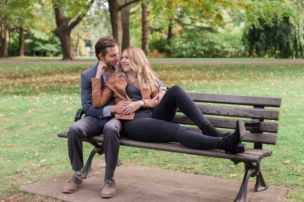 Couple in Victoria park Kitchener cuddling on bench