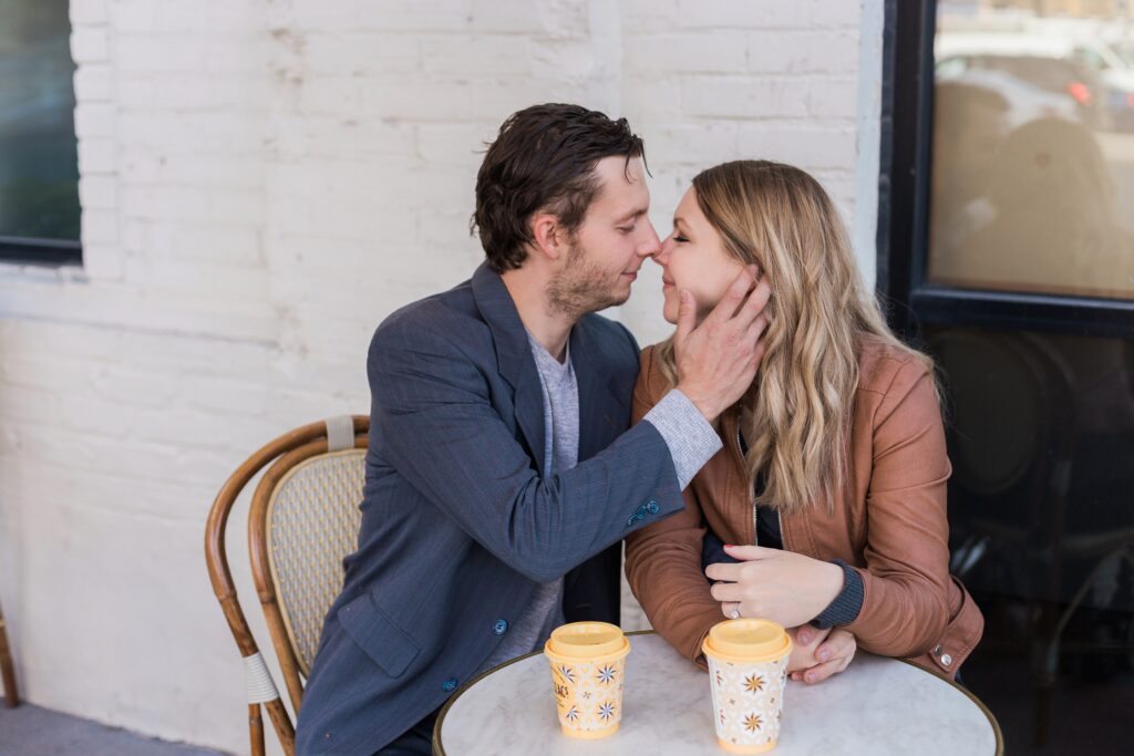 Couple almost kissing at table with coffee