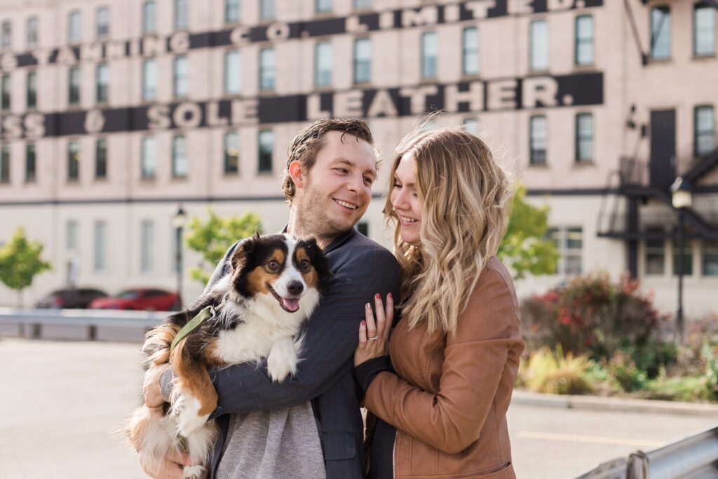 couple holding dog downtown Kitchener