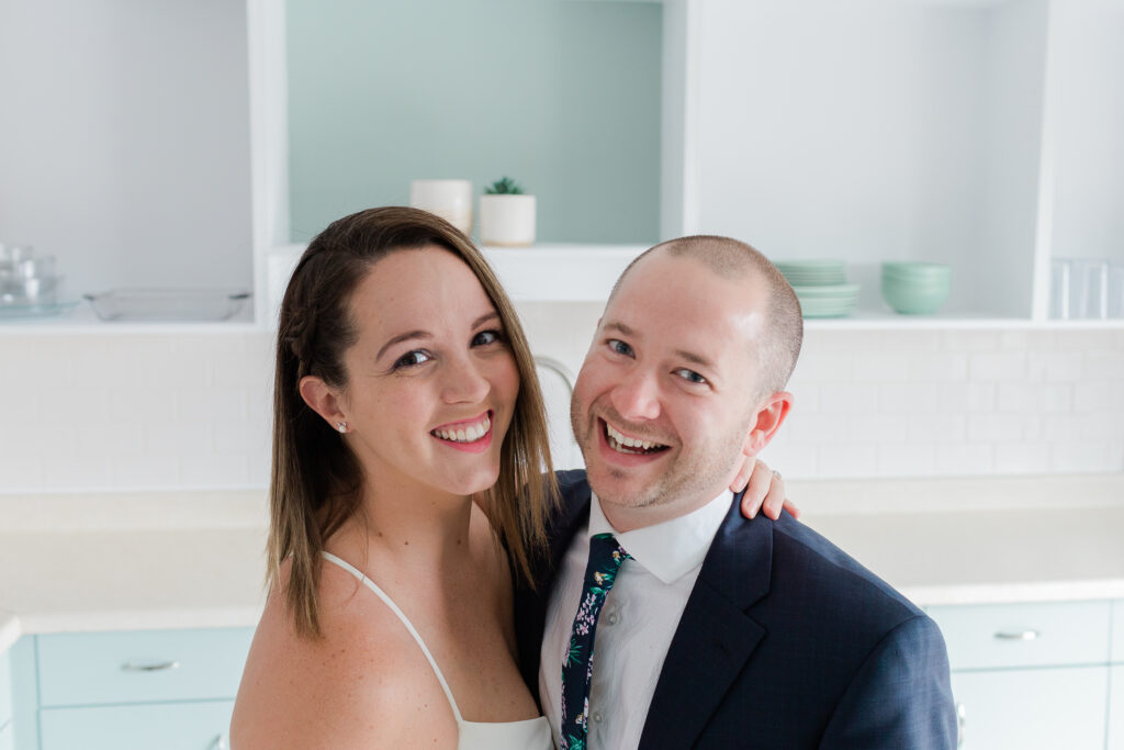 quarantined bride and groom laughing close up in kitchen