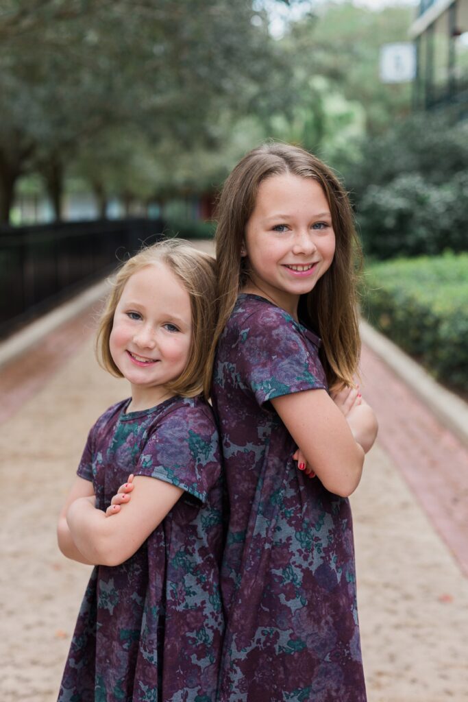 Sisters standing back to back for family photos in Disney's Port Orleans Resort