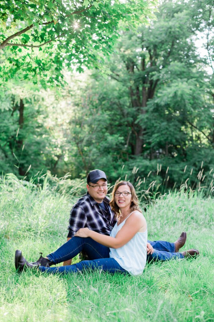 Couple smiling at camera for an engagement photo