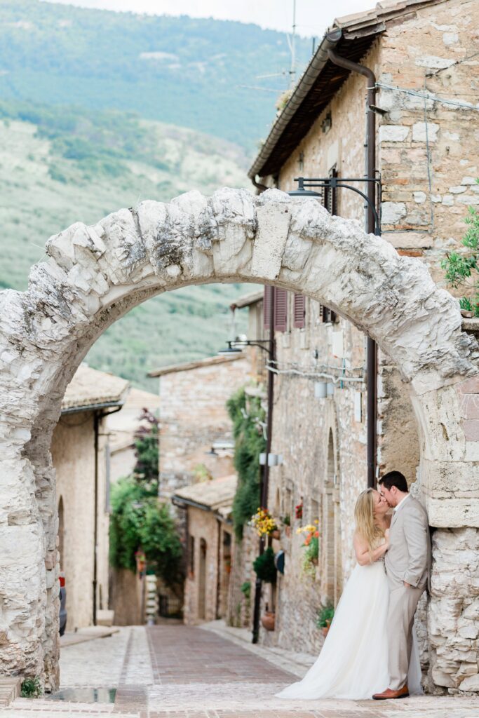Couple kissing under archway the day after wedding