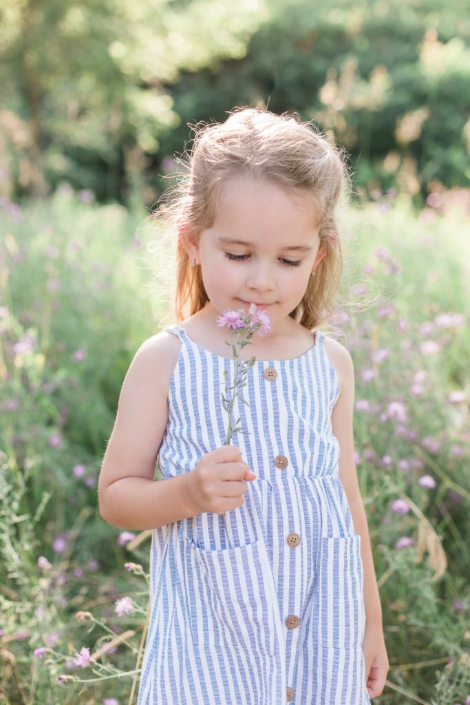 young girl smelling flowers