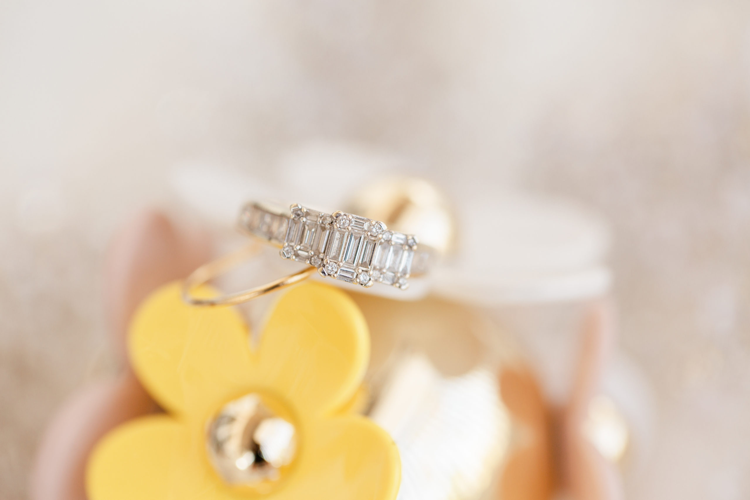 wedding ring details shot on yellow flower