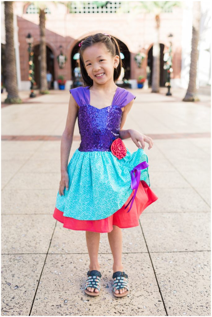little girl in disney dress at disney springs