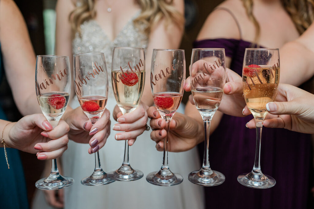 custom champagne glasses filled with champagne and a raspberry 