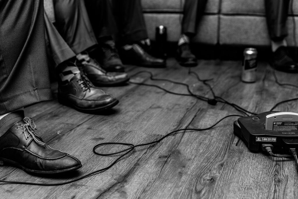 detail shot of men's shoes and cords from a gaming station