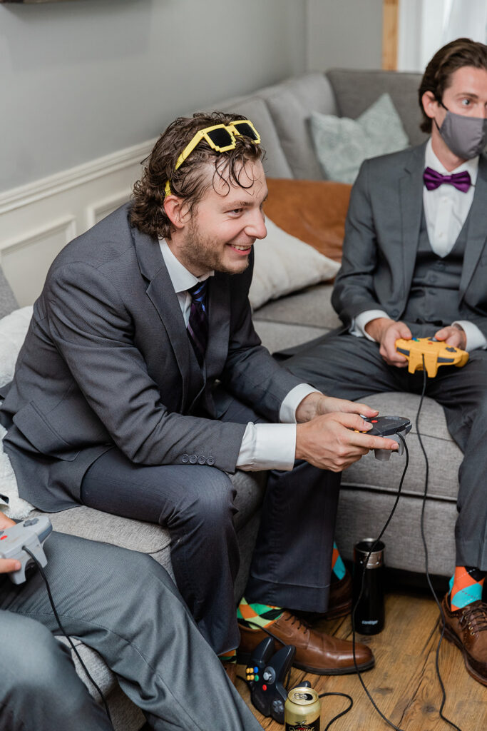 groom playing video games on his wedding day