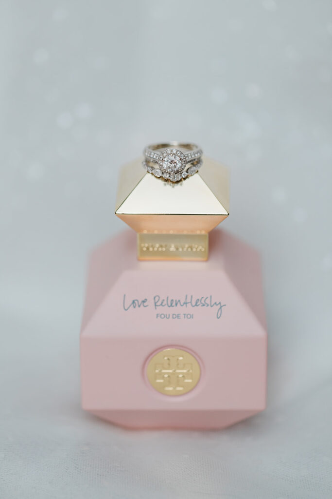 perfume bottle with diamond ring on lid