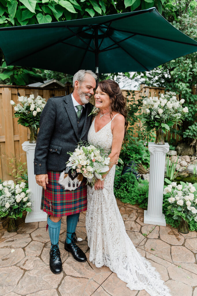backyard summer wedding in Kitchener with happy couple smiling