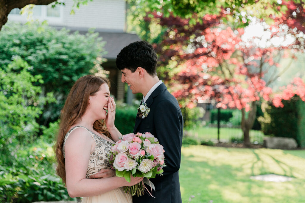 couple giggling at their intimate backyard elopement