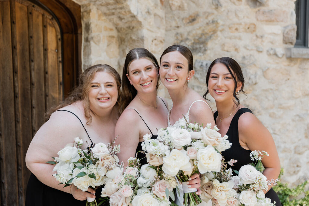 bride and bridesmaids snuggled in for a close up hugging photo