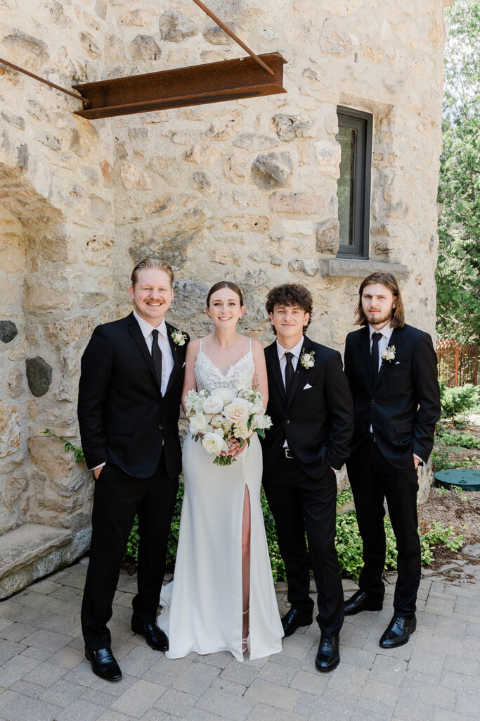 bride with groomsman in a formal portrait smiling at the camera