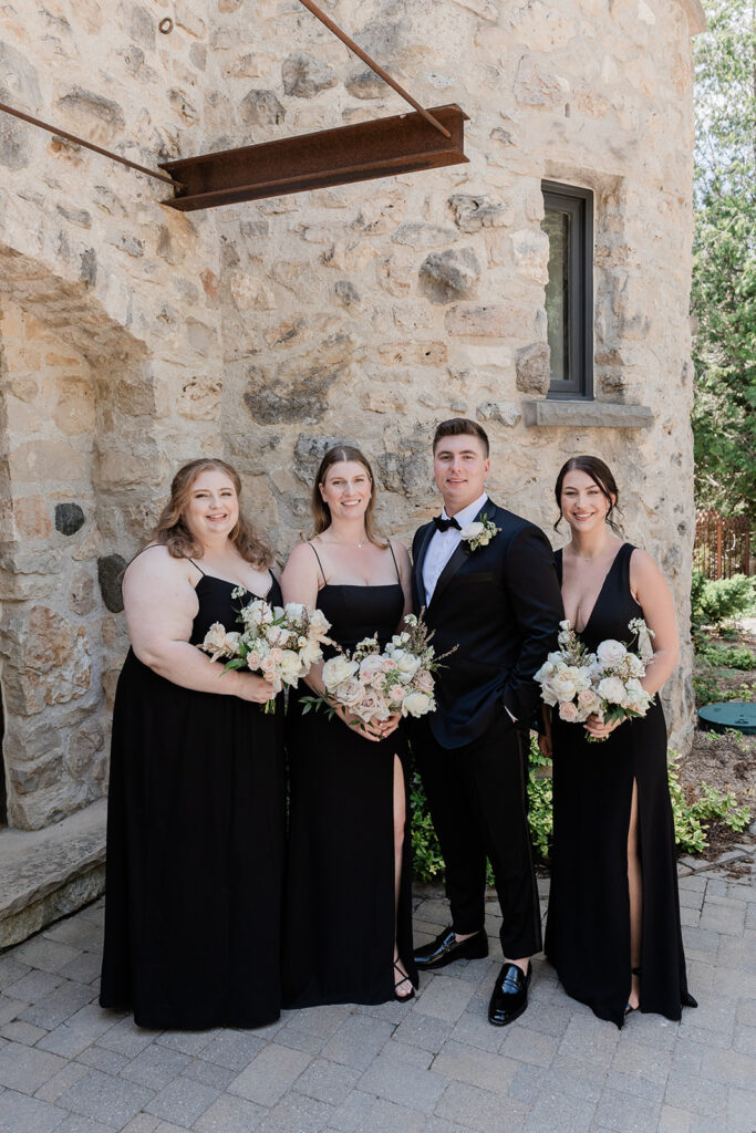 groom with bridesmaids in formal portrait