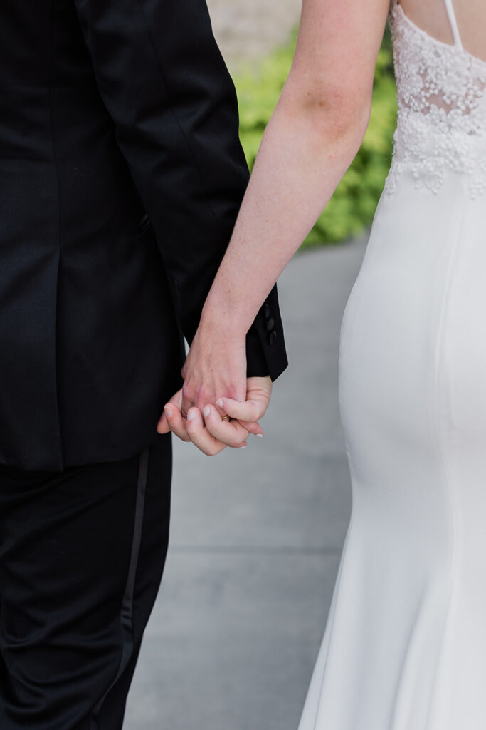 close up shot of bride and grooms hands