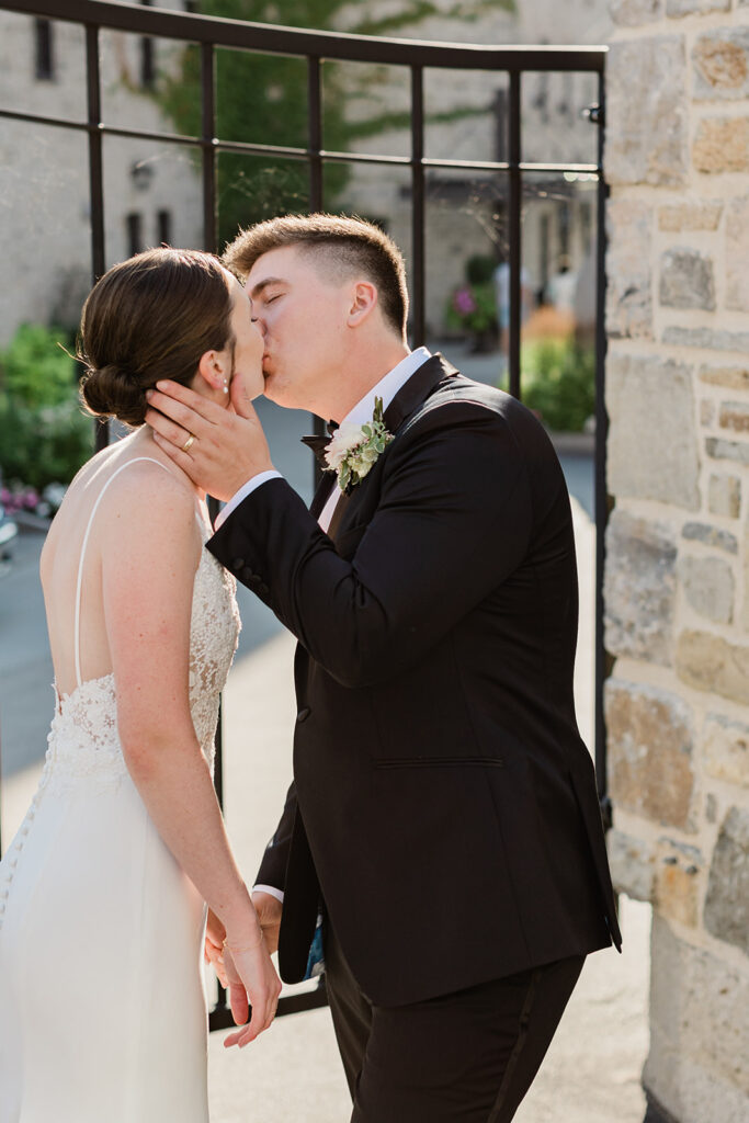 couples kissing in front of their Elora Mill Wedding Venue