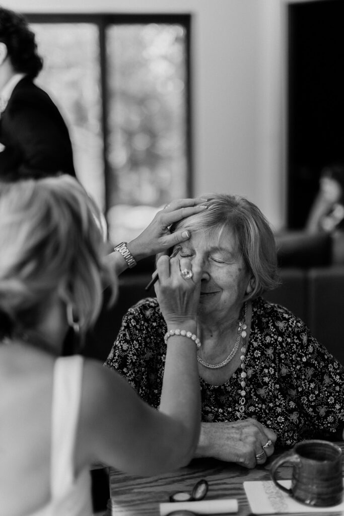 grandma getting her makeup done by aunt