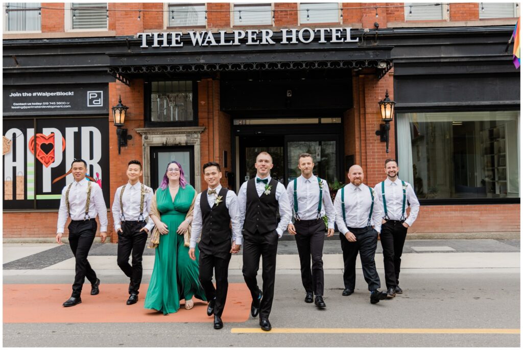 wedding party walking on street in front of Walper Hotel for a downtown wedding