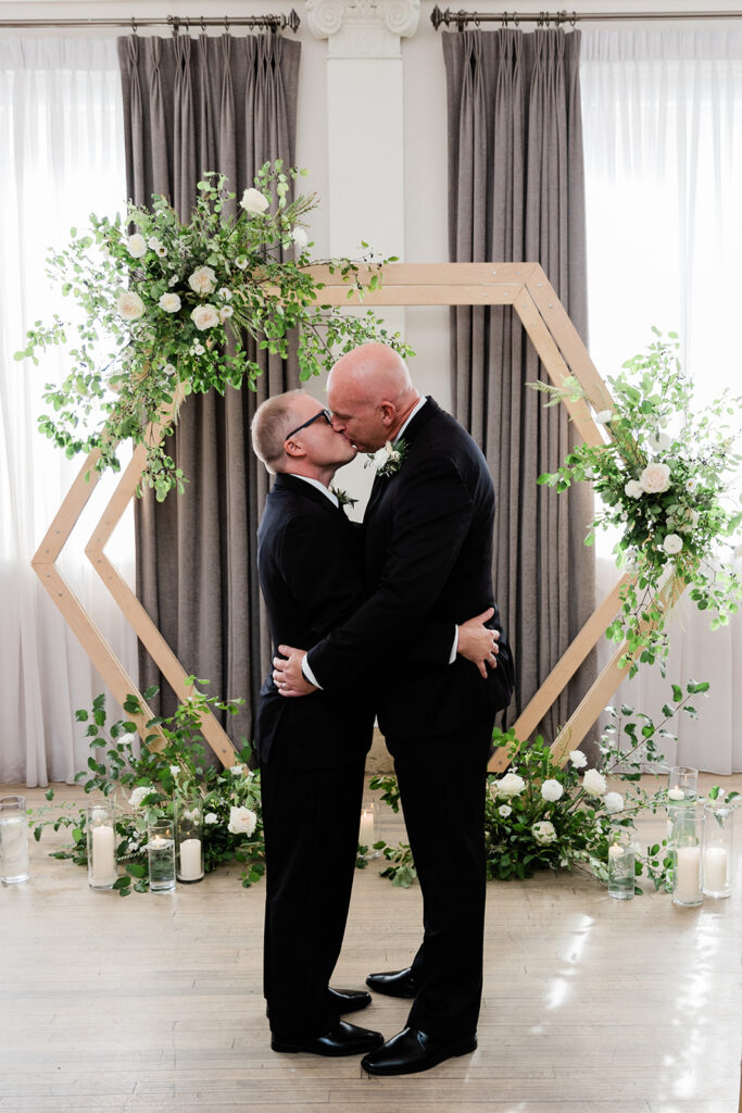 Couple sharing first kiss at Walper Hotel Wedding Ceremony